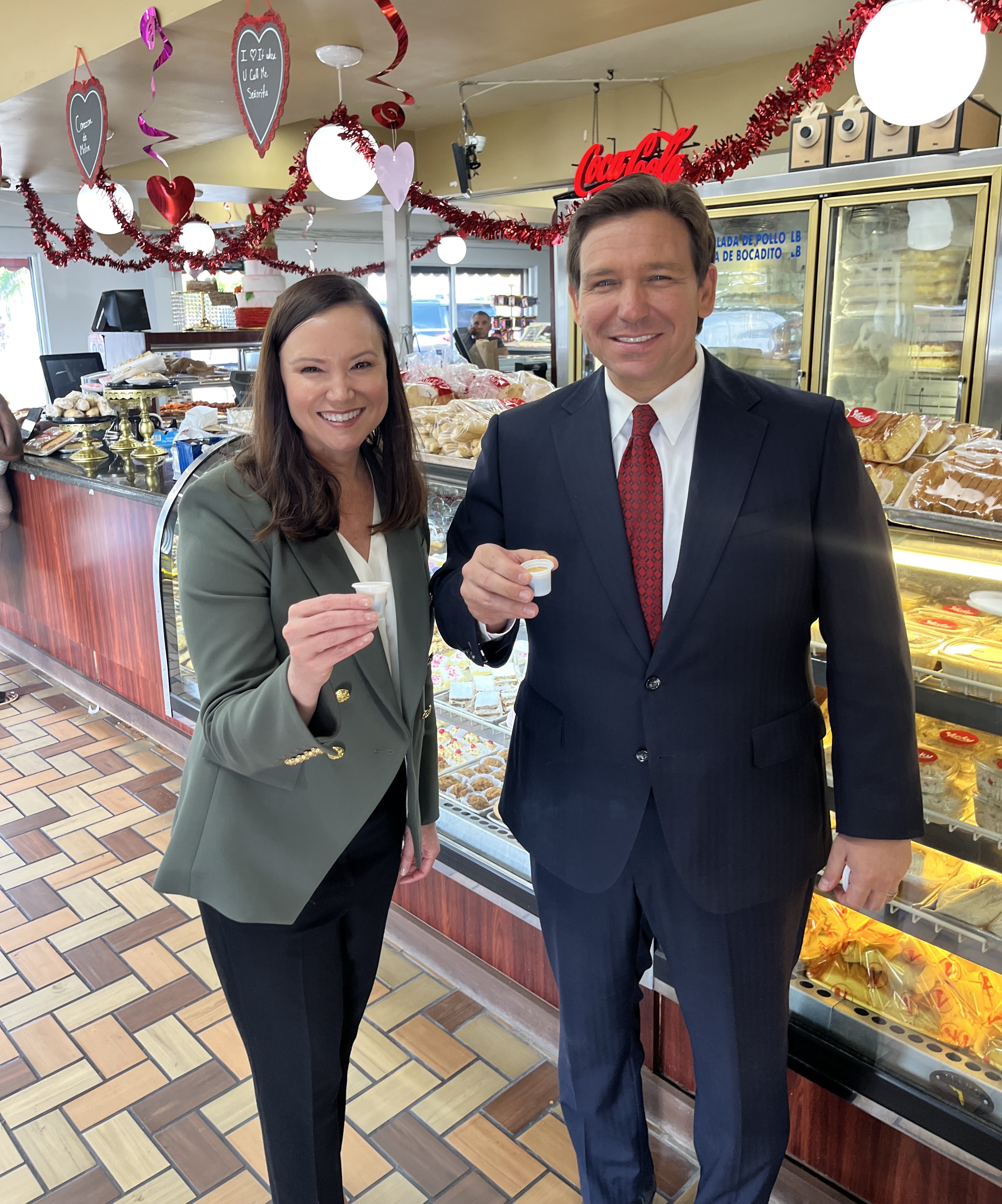 Attorney General Moody and Gov. DeSantis celebrating the announcement